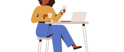 Black Woman Chatting On A Smartphone Sitting At The Cafe Table. Happy Freelancer Or Office Female Working Remotely Use A Laptop.